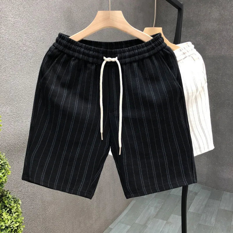 Man wearing black and white striped casual shorts with an elastic waistband and banded ankles.