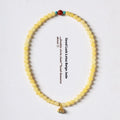 Yellow jade double ring bracelet with lotus seedpod design in hand-woven construction