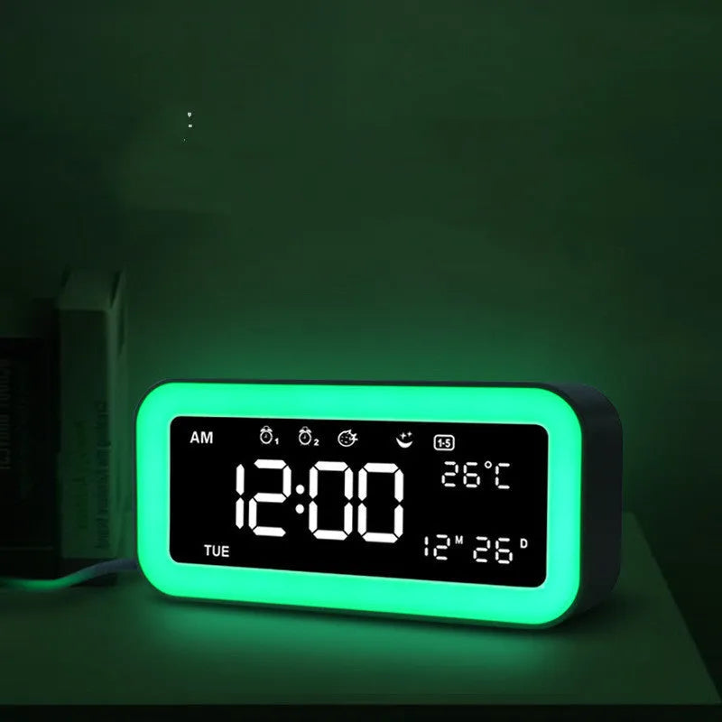 Blue rectangular LED digital alarm clock with multicoloured ambient light display.