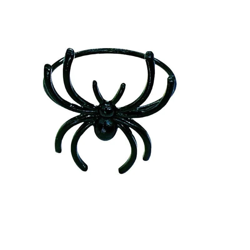 Set of six black metal spider-shaped napkin rings for Halloween table decoration.