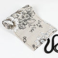 Square canvas pencil roll bag with black peony print design showing pencil pockets