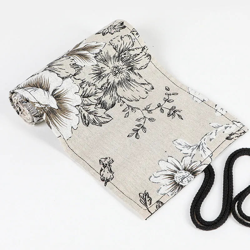 Square canvas pencil roll bag with black peony print design showing pencil pockets