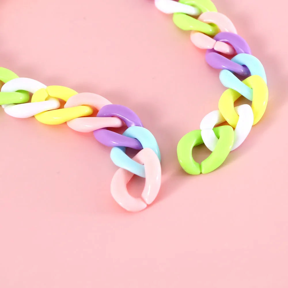 Macaron candy colour plastic collar for pet dog cat rabbit on a blue background.
