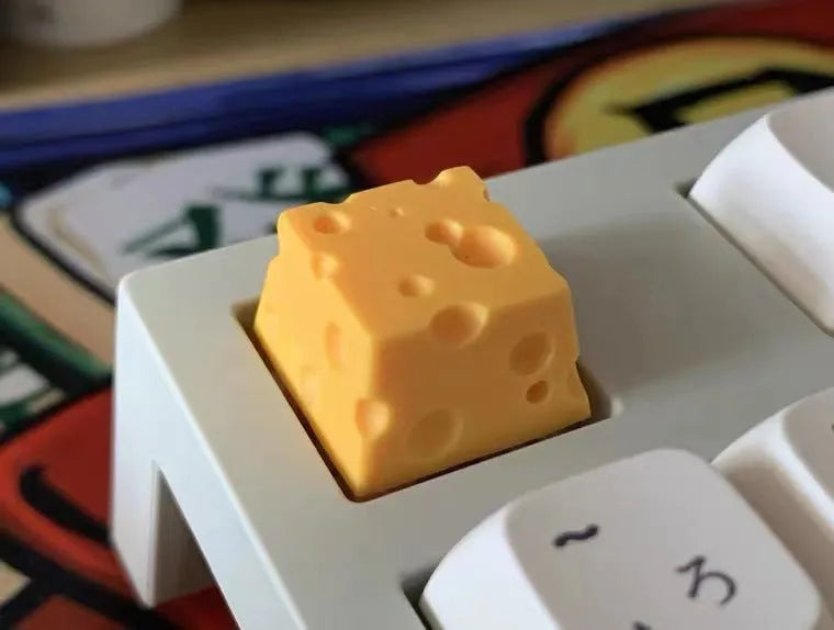 Solid yellow resin artisan key cap with detailed cheese design for MX mechanical keyboards.