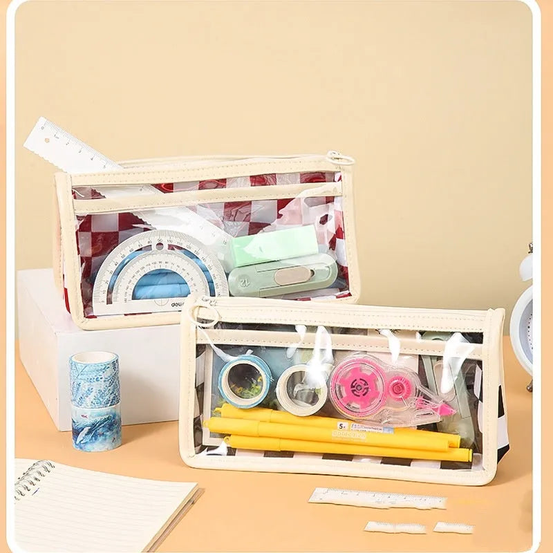 Transparent PVC pencil case with chessboard pattern, open to show large interior for pens.