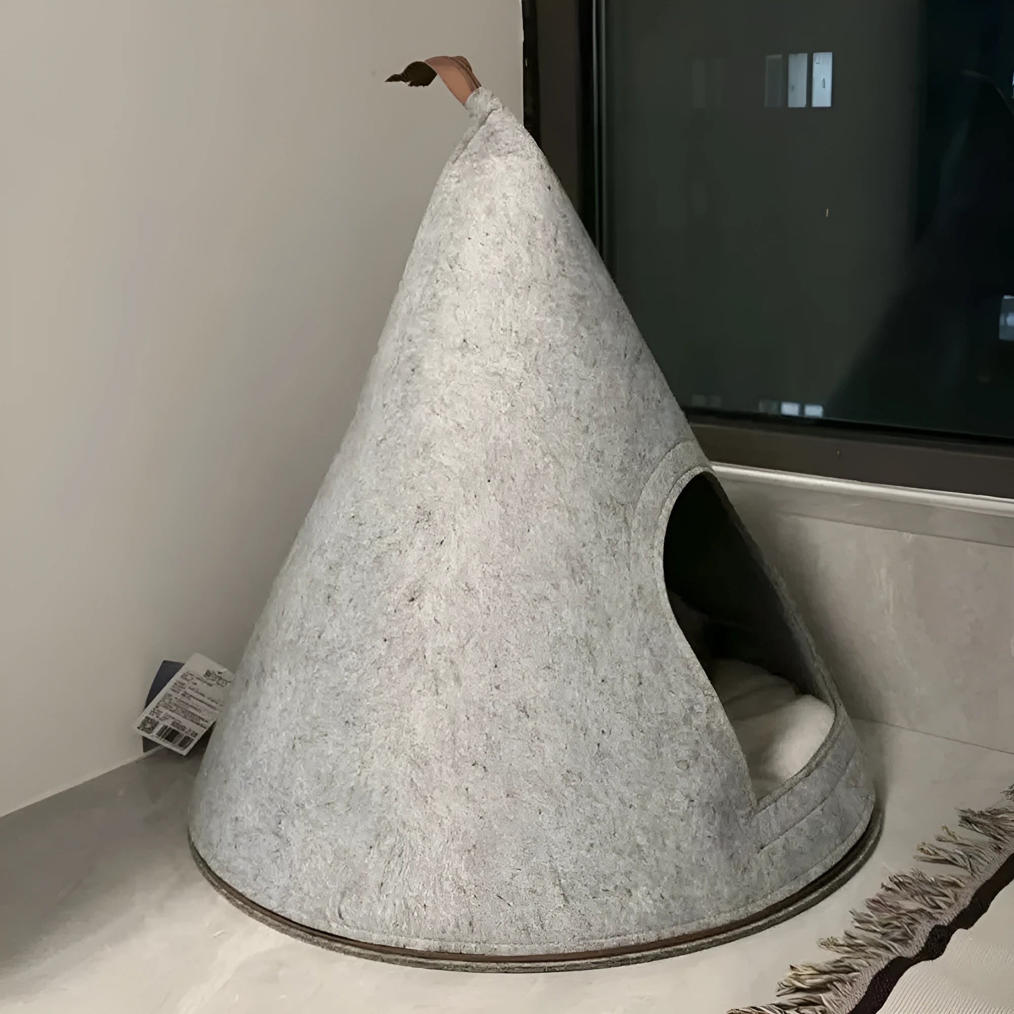 Grey handmade felt cone-shaped cat house with enclosed tent-style design