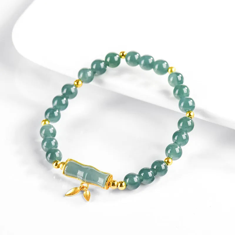 S925 sterling silver bracelet for women with a blue water round bead and cargo jade charm.
