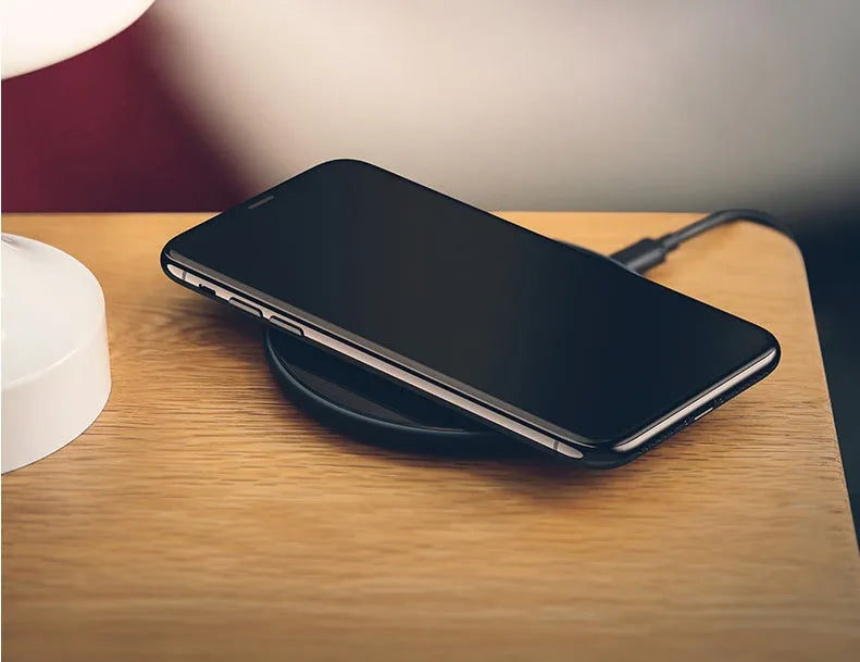 Glass disc wireless charger showing black and white colour options with charging indicator