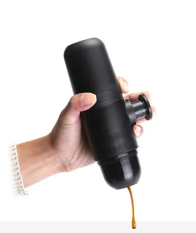 Black portable manual coffee machine showing compact 6cm design with pressure system for travel brewing