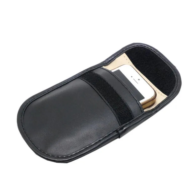 Black microfiber Faraday pouch for blocking car key and credit card signals, shown with a key fob inside.