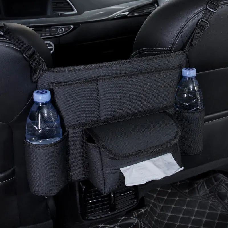 Black leather car seat hanging storage organiser for tissue boxes, shown between vehicle front seats.