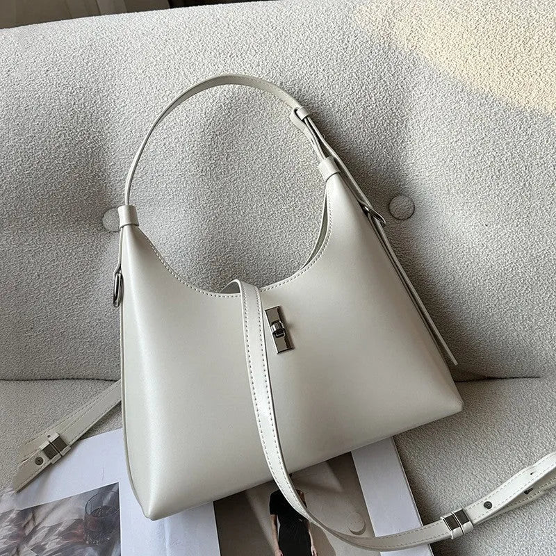 Genuine leather dumpling-shaped crossbody shoulder bag in apricot colour with street-trend details.