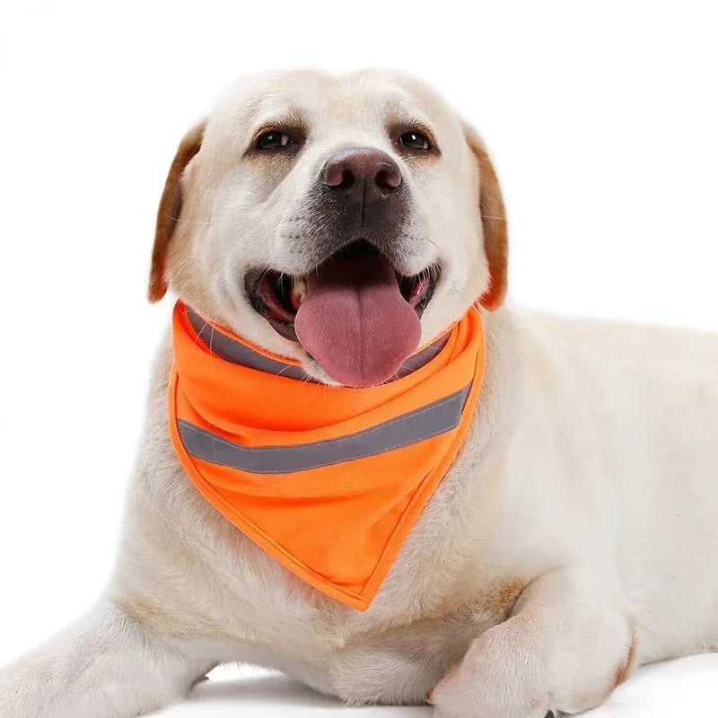 Yellow and orange polyester dog bandana with reflective stripes laid flat, showing adhesive strap closure.