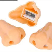 Flesh coloured plastic pencil sharpener with geometry shape on a white background.