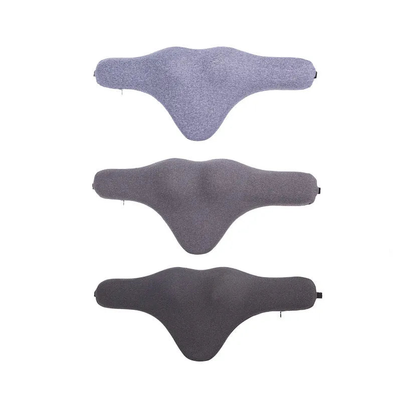 Dark grey memory foam car neck pillow on a car headrest.