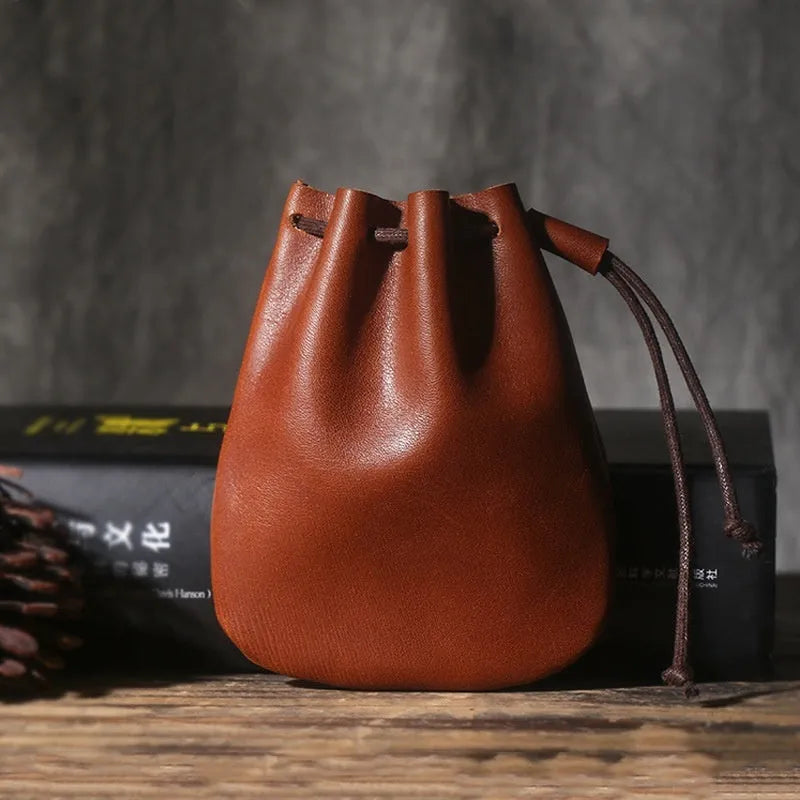 Genuine cowhide leather drawstring bundle wallet in retro style shown in black and chocolate colours.