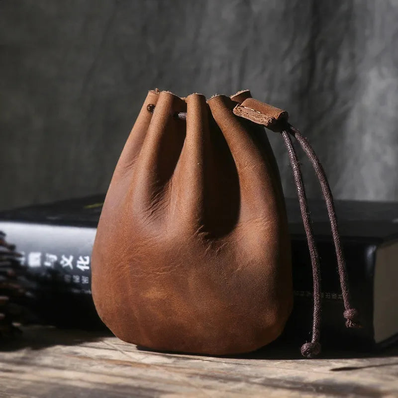 Genuine cowhide leather drawstring bundle wallet in retro style shown in black and chocolate colours.