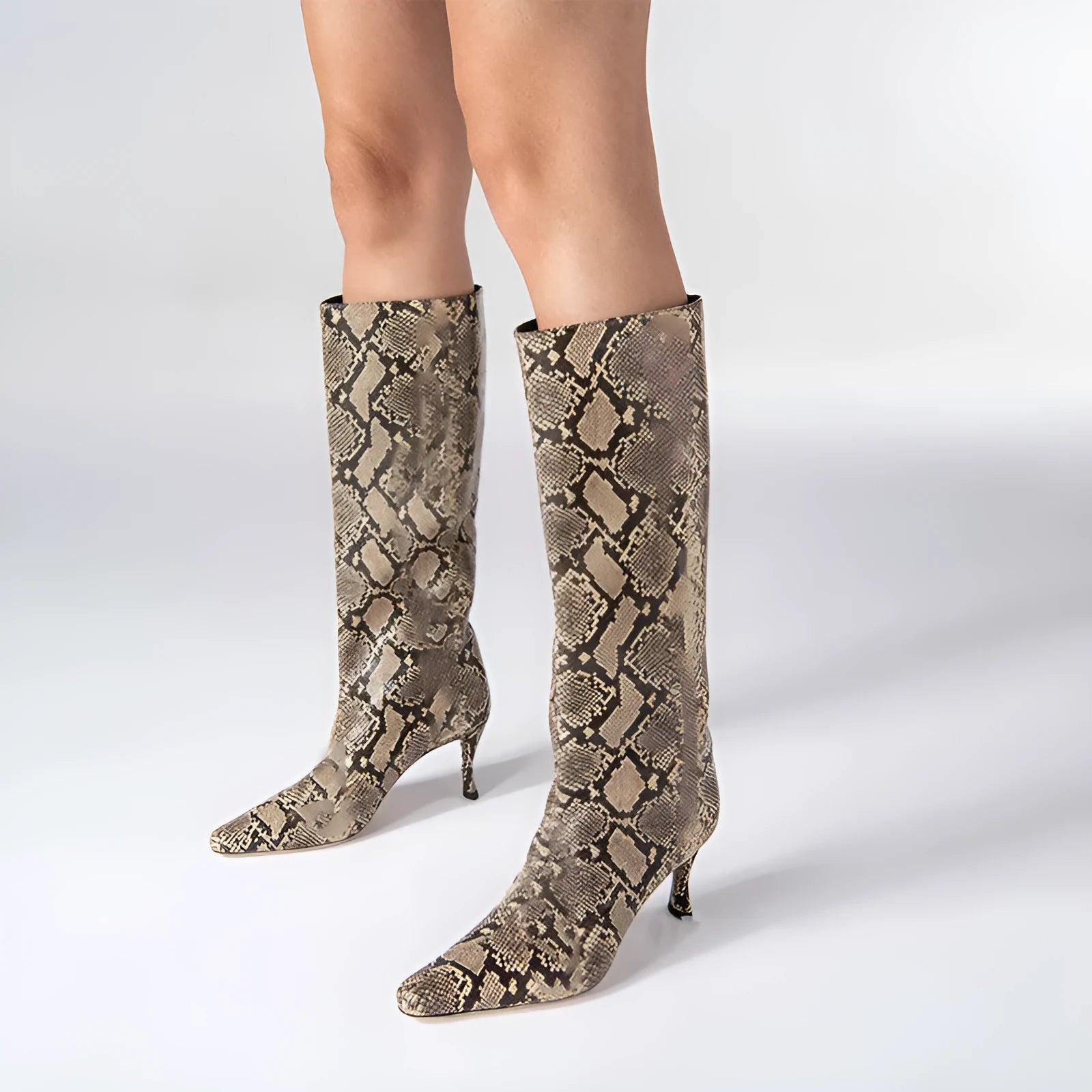 Women's black square toe cowboy boot with microfiber upper on a wooden background.