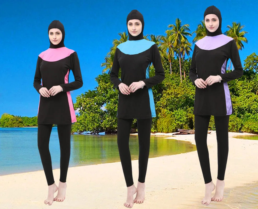 Women's black long sleeve hooded swimsuit top and pants set for swimming.