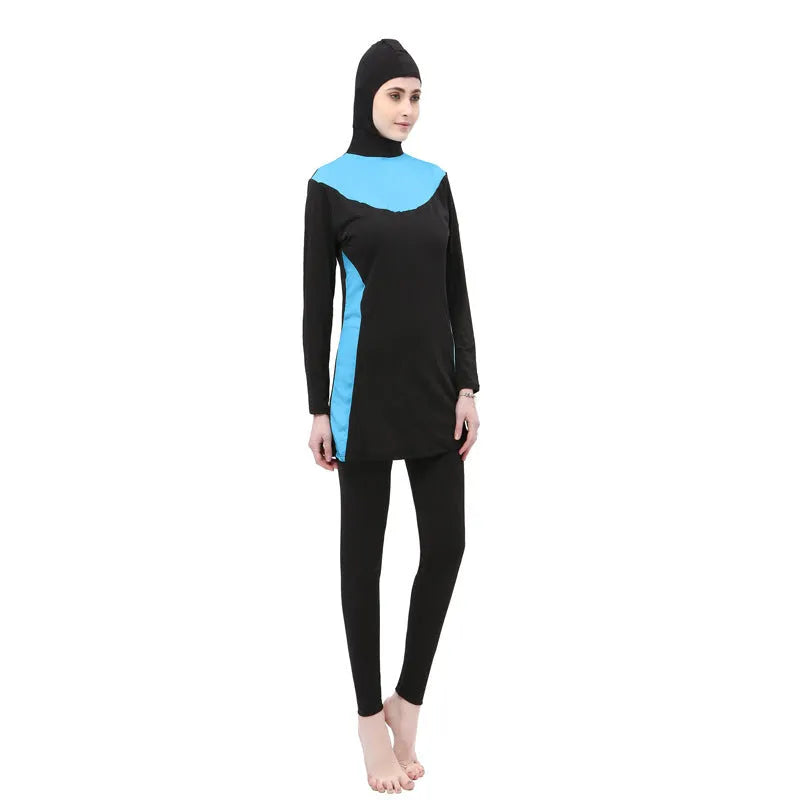 Women's black long sleeve hooded swimsuit top and pants set for swimming.
