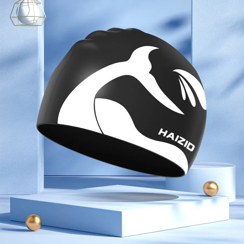 Silicone swim cap with whale tail pattern and integrated ear protectors in multiple colour options