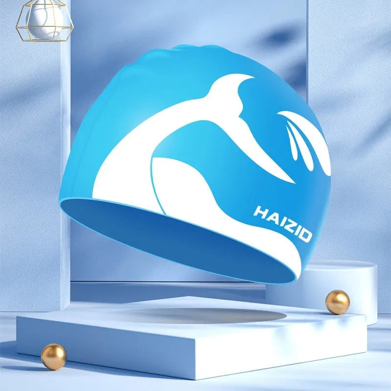 Silicone swim cap with whale tail pattern and integrated ear protectors in multiple colour options