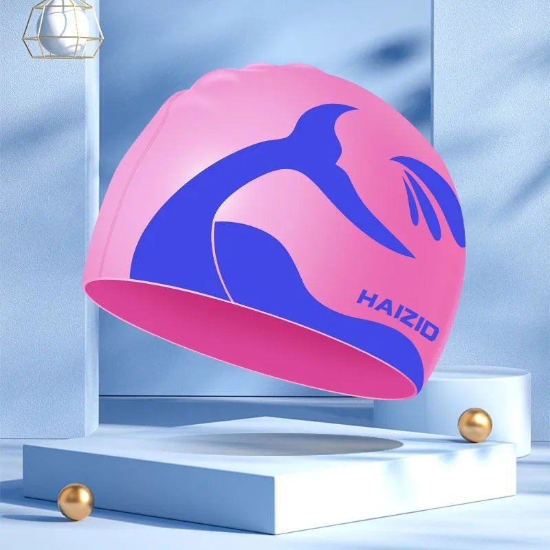 Silicone swim cap with whale tail pattern and integrated ear protectors in multiple colour options