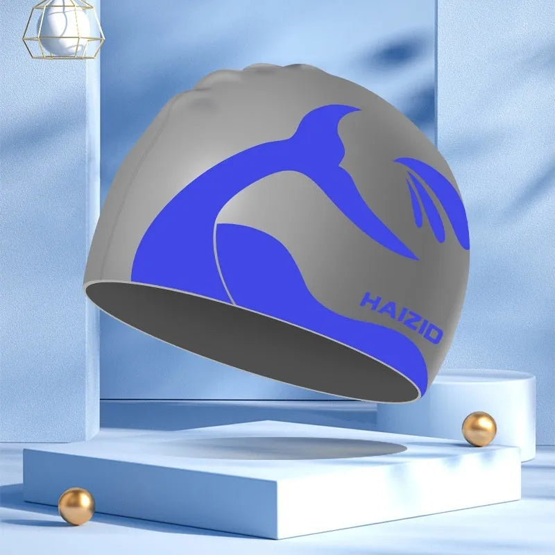 Silicone swim cap with whale tail pattern and integrated ear protectors in multiple colour options