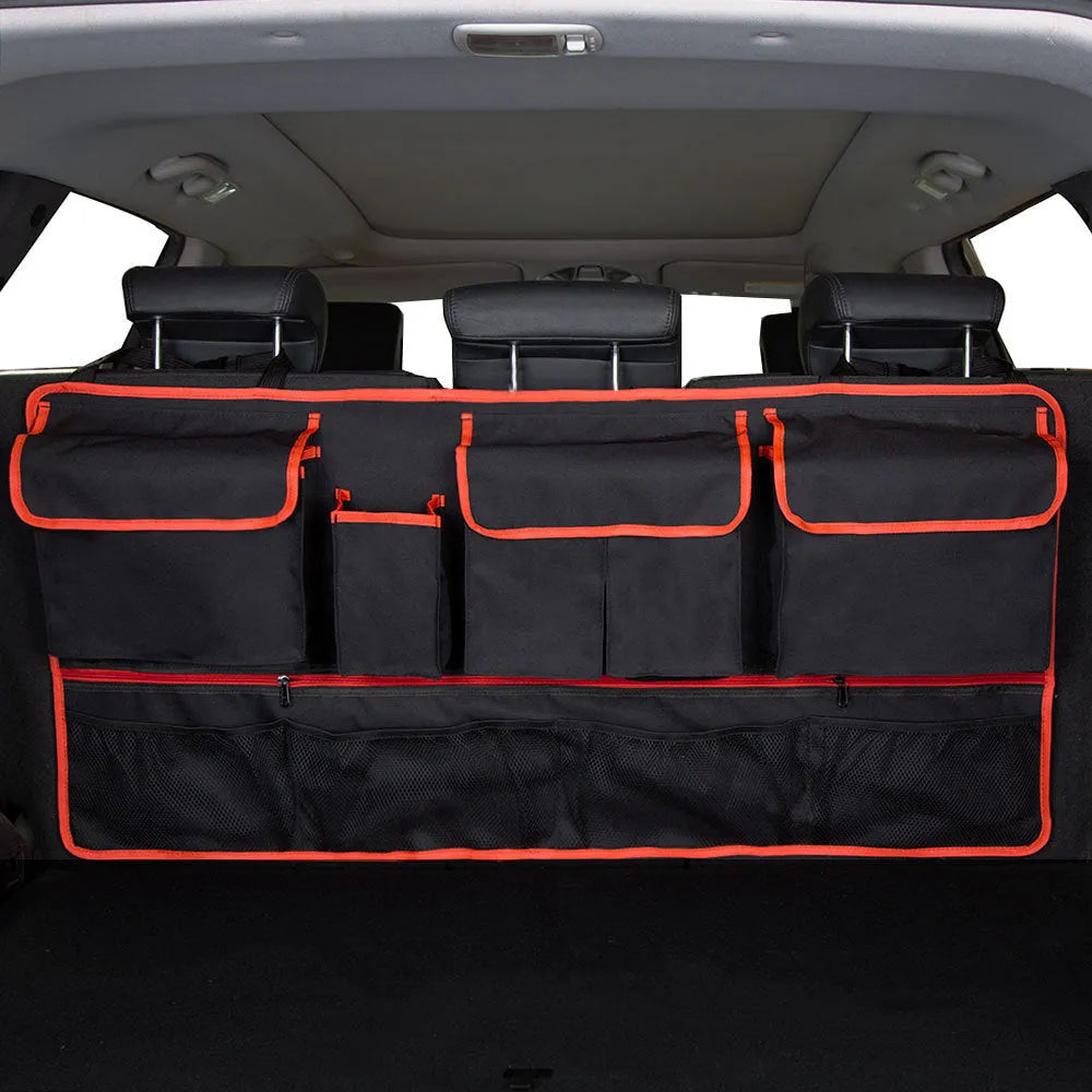 Black car boot hanging storage organiser made of Oxford cloth with a handle, shown hanging.