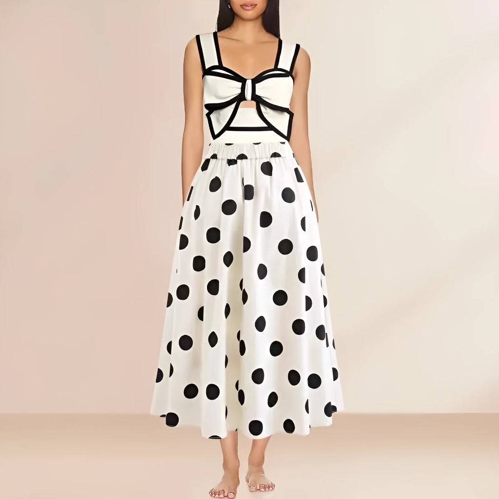 Women's black one-piece swimsuit with white skirt and bow detail on front.