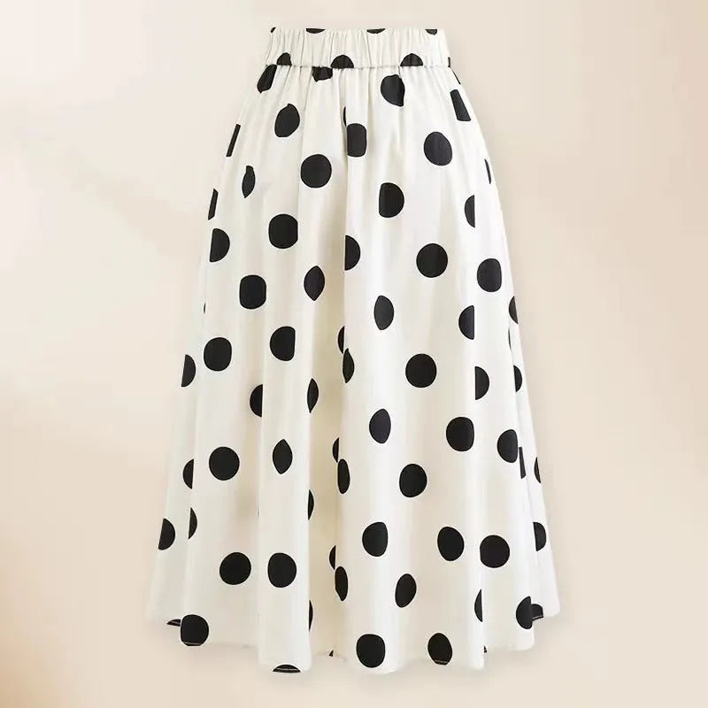 Women's black one-piece swimsuit with white skirt and bow detail on front.