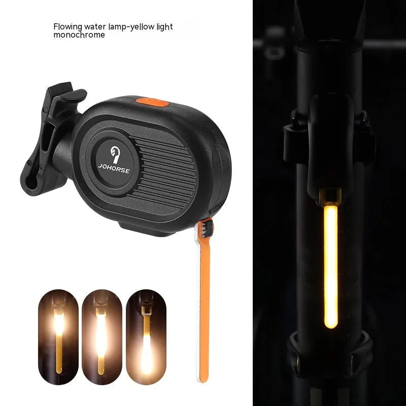 Bicycle taillight displaying a blue waterfall or running water light effect on a dark background.