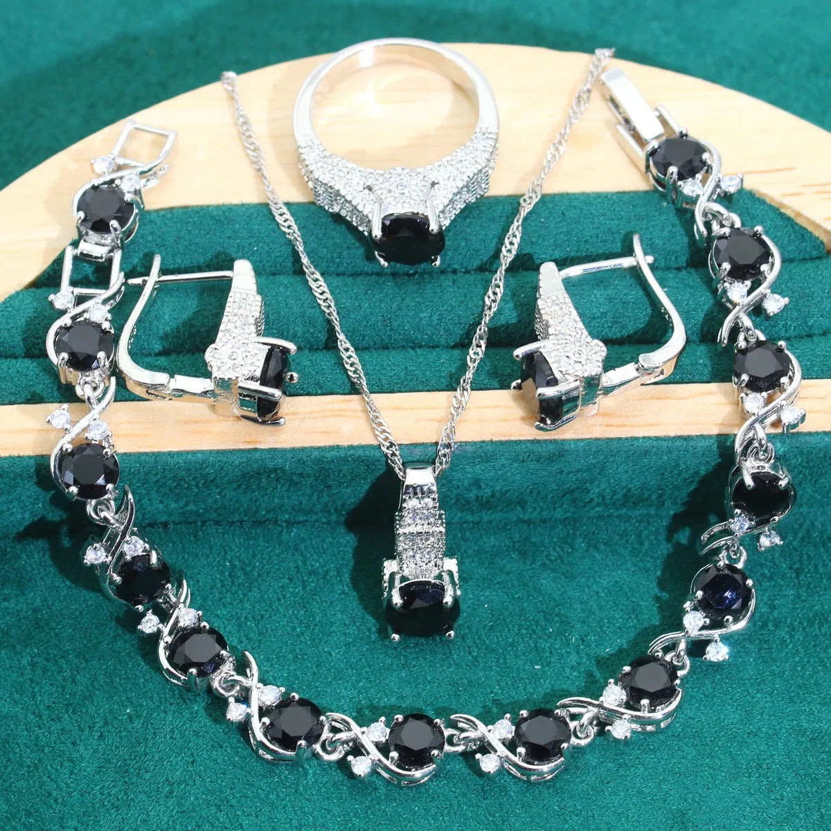 Bridal four-piece jewellery set showing necklace, earrings, ring and bracelet with water wave chain design