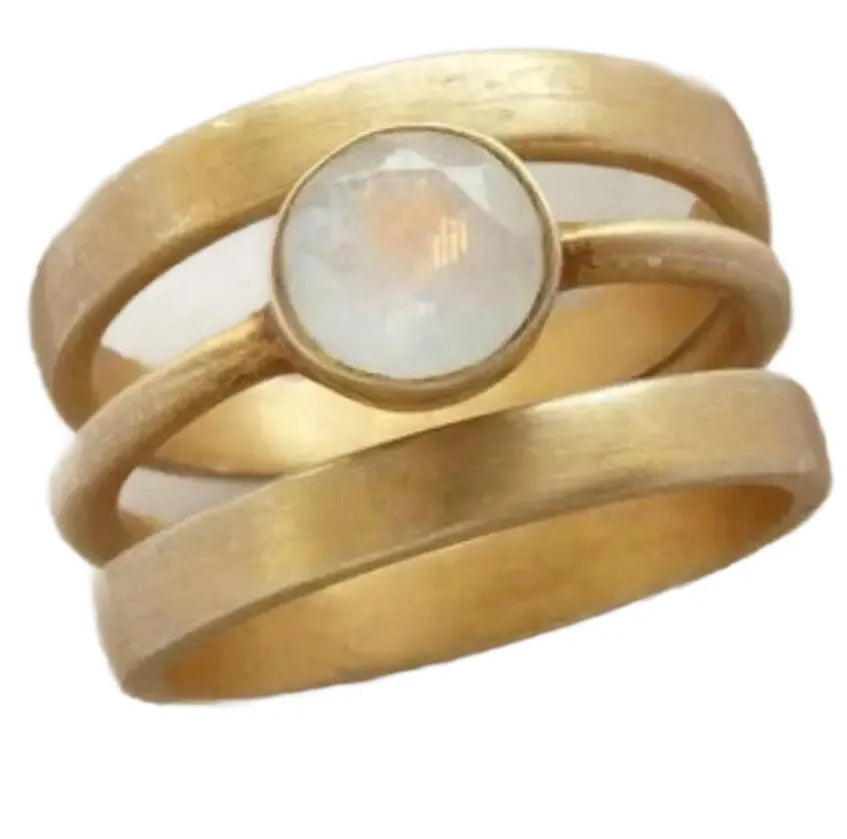 Gold-plated geometric ring with a white chalcedony stone micro-inlaid in a hollow setting.