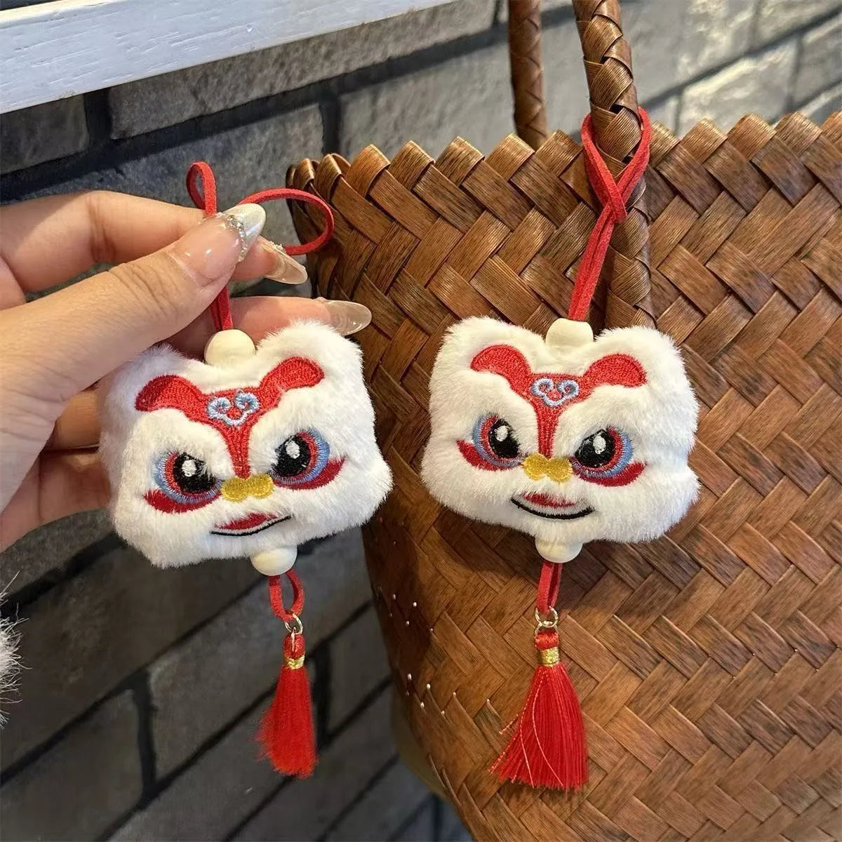 Blue and yellow handmade plush lion keychains with star stone decoration on a cartoon style tassel ornament.