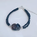 Obsidian cat climbing bracelet with hand-carved design on adjustable band