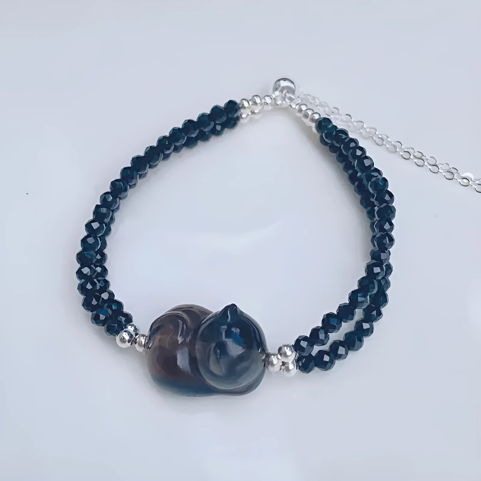 Obsidian cat climbing bracelet with hand-carved design on adjustable band