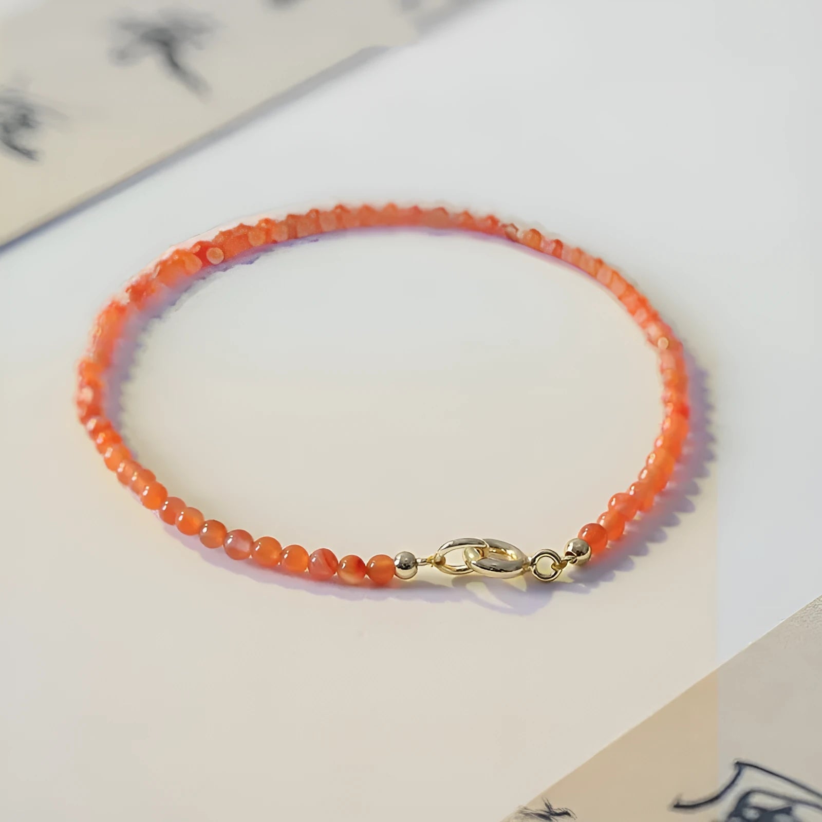 Women's Southern Red Agate bracelet in cherry red and persimmon red with 3mm cut surface, shown in retro style.