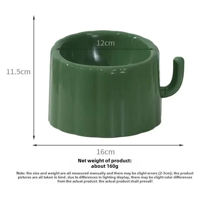 Dark green cat bowl with cactus design and anti-slip base on a wooden surface.