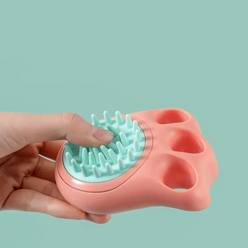 A blue cat claw-shaped pet bath brush for grooming and massaging dogs or cats during washing.