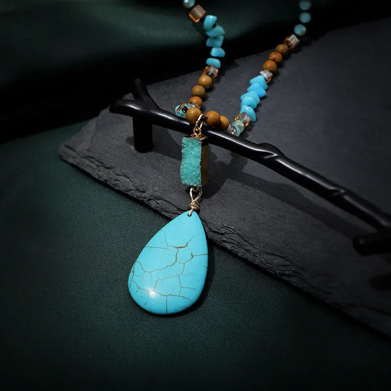 Blue turquoise gem inlaid drop pendant on a long ball bead necklace chain