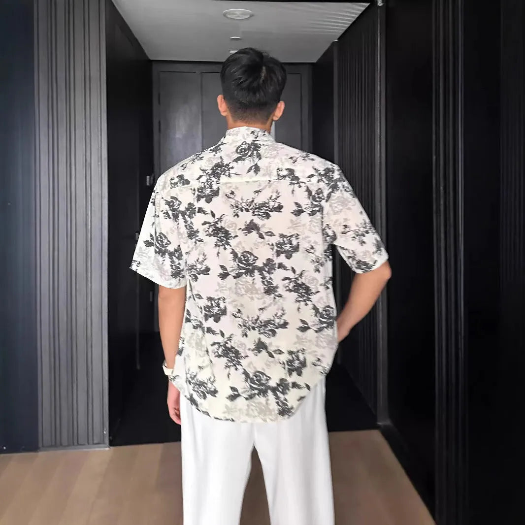 Women's loose casual short-sleeve shirt with a floral print pattern in white or black.
