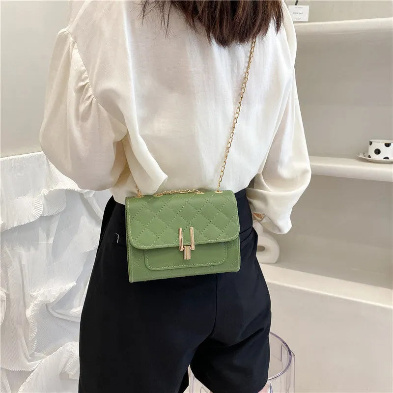 Women's black crossbody bag with diamond lattice chain strap showing 17.5cm width dimensions
