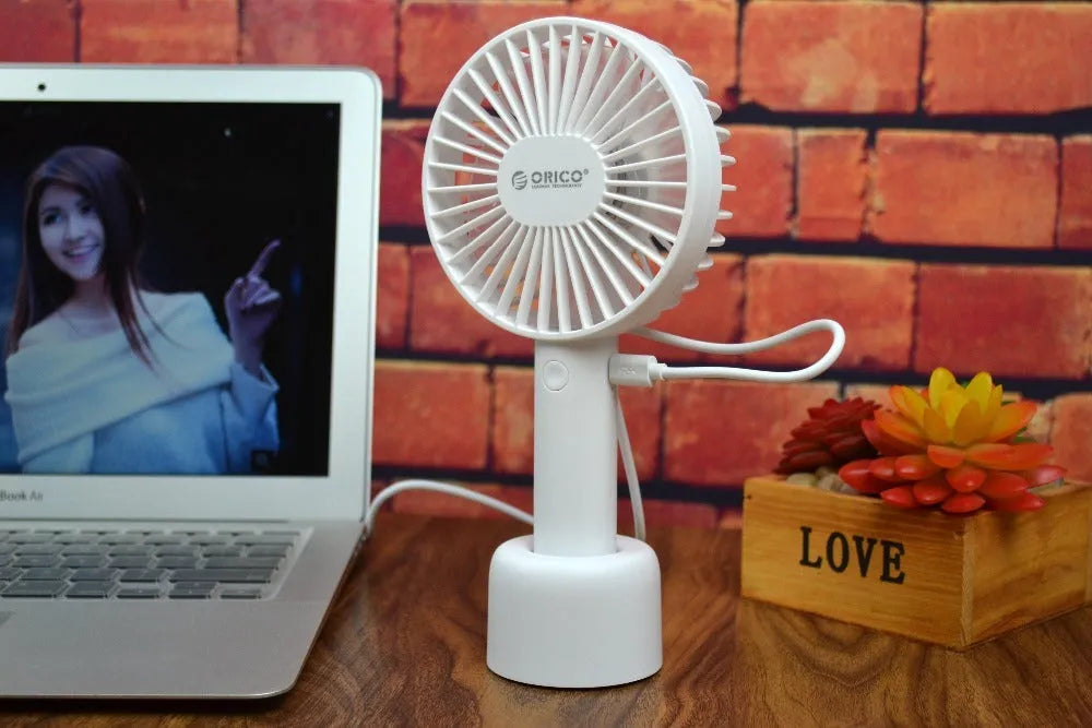 White ORICO FH1 portable USB rechargeable handheld desk fan with three-speed settings.