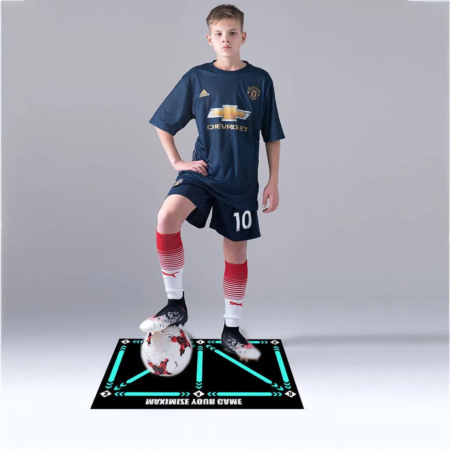 Black rectangular football training mat on grass for skills practice.