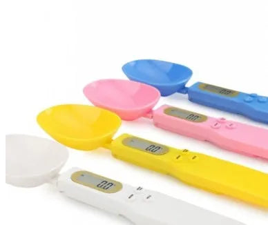 White digital kitchen scale with LCD display and spoon-shaped weighing surface for precise ingredient measurements