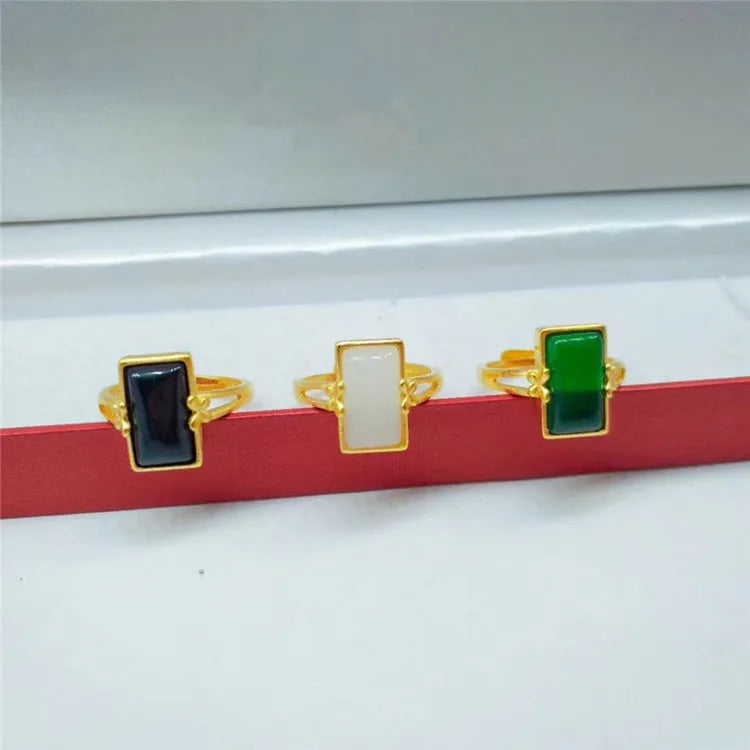 Gold-plated brass ring with a long green gemstone on an adjustable band.