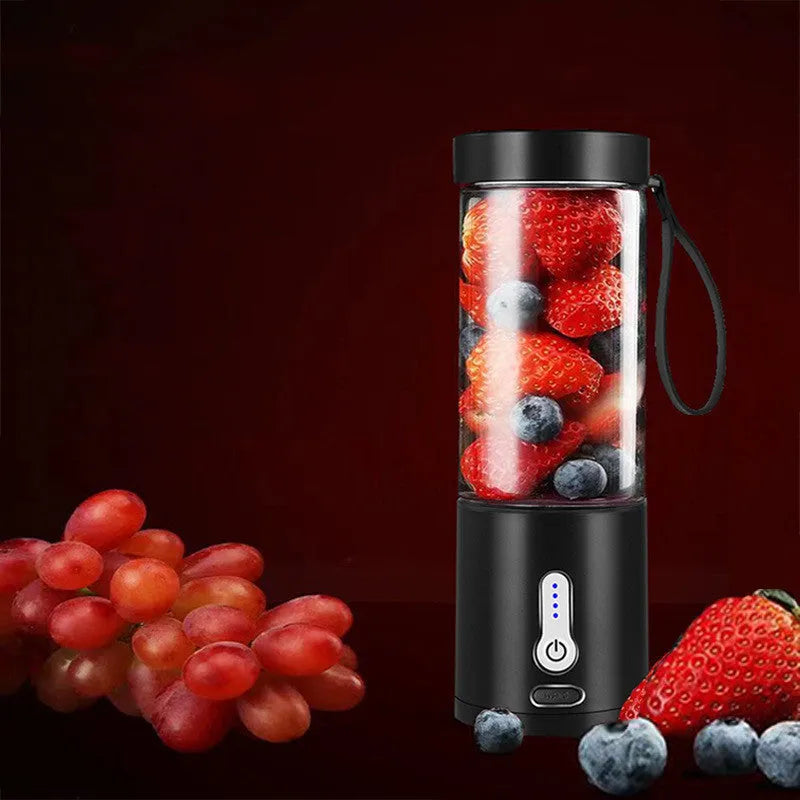 Black portable hand blender with transparent 530ml measuring cup and five-blade cutter head.