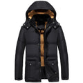 Man wearing a black loose fit double-breasted velvet padded jacket with a hood.