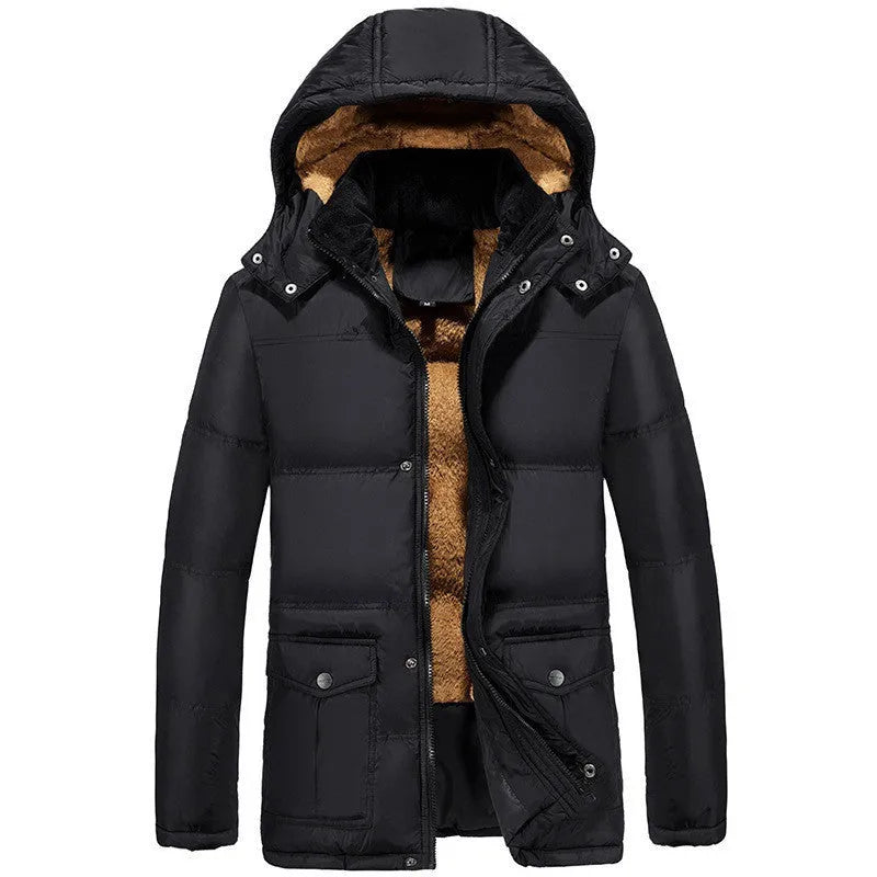 Man wearing a black loose fit double-breasted velvet padded jacket with a hood.